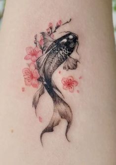 a woman's stomach with a fish and flowers on it