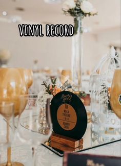 there is a table with wine glasses and an award on it that says vinyl record