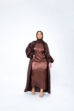 The Organza Abaya is statement outfit for any event. It's super lightweight yet so simple with the prettiest sheen. Complete the look with our matching long sleeve satin slip dress and a pair of strappy heels for a luxe finish or make it into a more casual look. *Please note that the color displayed in the picture might be slightly different due to the color resolution and lighting. Fabric Description & Care: Balloon Sleeves with elastic cuff Double Lined Material: Silk/Organza Dry Clean for bes Elegant Satin Abaya For Party, Evening Satin Maxi Abaya, Evening Satin Maxi-length Abaya, Elegant Long Sleeve Brown Abaya, Elegant Silk Abaya For Party, Silk Long Abaya For Party, Silk Party Abaya, Elegant Satin Maxi Abaya, Silk Long Sleeve Abaya For Party