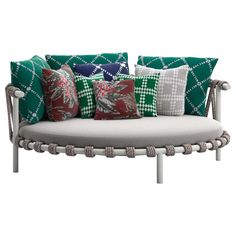 a white couch with green and red pillows on it's back end, in front of a white background