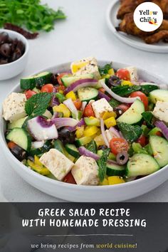 greek salad recipe with homemade dressing in a bowl on a table next to olives and pita bread