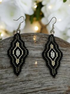 Add a pop of colour to your look with these beautiful  beaded earrings, made with silver, black and gray seed beads. These diamond shaped statement earrings are casual and fun, the perfect accessory for day or night.  These boho earrings are the perfect gift for a wedding, birthday, Christmas, anniversary, engagement, Mother's Day, Valentine's Day, woman's day, bridesmaid proposal, and many more. ABOUT * Beaded earrings * Dangling style * Measurements: -Height: 3 inches -Width: 1 inches  If you Festival Black Bead Drop Earrings, Black Teardrop Beaded Earrings, Bohemian Black Teardrop Beaded Earrings, Elegant Black Earrings With Silver Beads, Black Teardrop Earrings With Black Beads, Black Earrings With Silver Beads As Gift, Traditional Black Handmade Earrings, Traditional Black Beaded Earrings For Party, Bohemian Black Earrings With Silver Beads