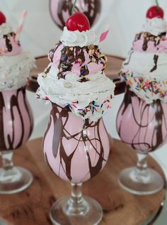 three ice cream sundaes with sprinkles and cherry on top