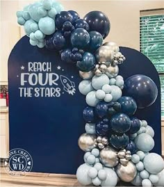 the balloon arch is decorated with blue, silver and white balloons that spell out the word'the will world '