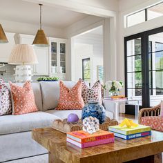 a living room filled with lots of furniture and pillows on top of a wooden table