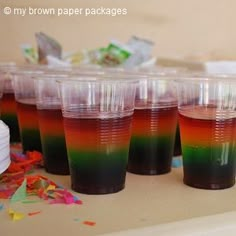 there are many cups with different colored liquids in them