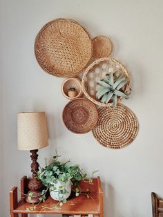 the wall is decorated with wicker baskets and succulents