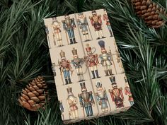 wrapping paper with nutcrackers and soldiers on it is tied to a pine tree