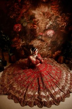 a woman in a red dress is sitting on the floor