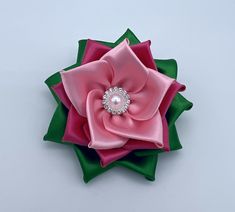 Floral Adornment - Collection of Kanzashi Flower Corsage Brooch  You can wear this corsage to any occasion. Ex. weddings, church events, banquets, sorority events, prom, and formal events. This beautiful design will demonstrate your elegant taste and surely add more charm to your unique personality. It's a Great gift to give for birthdays, Mother's day, Christmas, or simply Just Thinking of You. You can wear this corsage with a blazer, denim jacket, dress, or blouse. So many options. All corsages are handmade when ordered. It takes 3-5 business days to be shipped from the date the order was placed. Kanzashi Flower diameter size: ~3.5 inches. Pink and Green (3 layers) All Gold or Silver (2 layers) Centers can vary based on what's in stock but will be some variation of pearls and rhinestones Denim Jacket Dress, Sorority Events, Kanzashi Flowers, Church Events, Flower Corsage, Green Gold, Sorority, Formal Event, Pink And Green