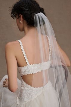 the back of a woman wearing a wedding veil