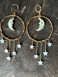 Beautiful moon hoop statement earrings that I love!! Made with vintage 70s mother of pearl shell man in the moon face crescent moon charms and star beads. Brass wire, upcycled vintage brass chain and vintage gold plated brass hoops. New gold tone hypoallergenic ear hooks Size 5 x 2 inches Comes in recycled compostable gift box and mailer Ethically sourced Lightweight Hypoallergenic Moon Hoop Earrings Star Dangles Celestial Statement Jewelry Crescent Moon Face Wire Wrap Hoop Earrings, Moon Wire Earrings, Wire Charms, 70s Accessories Jewelry, Wire Wrapped Crystal Pendant, 70s Jewelry, Moon And Star Earrings, Beads Craft Jewelry, Retro Accessories