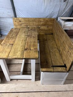 two benches made out of wood sitting on top of a wooden floor next to each other