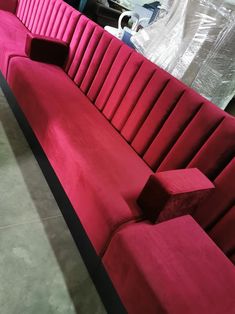 a large red couch sitting on top of a floor