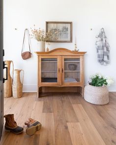 a wooden cabinet sitting on top of a hard wood floor