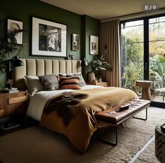 a bed sitting in a bedroom next to a window with lots of plants on it