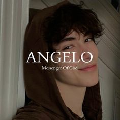 a young man wearing a brown hoodie with the words angelo on it in front of him