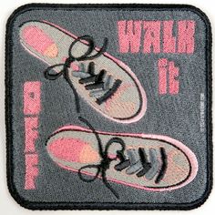 a pair of tennis shoes on a black and pink patch