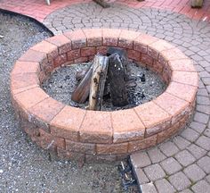 a fire pit made out of bricks on the ground