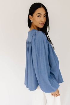 this retro-inspired long sleeve top will take you from summer picnics to fall photoshoots with ease. made with a dark wash denim-esque material, this elevated top features long balloon sleeves + a flowy silhouette. dress it up with trousers + heels, or down with white jeans + sandals. medium wash // high neckline, buttons, balloon sleeves, elastic cuffs paired with our camelot wide leg denim model is 5'8" + wearing a small measurements are approximate + taken while laying flat small : bust 42” l Denim Tops For A Day Out In Spring, Relaxed Fit Denim Top For Spring Day Out, Spring Bishop Sleeve Blouse In Relaxed Fit, Spring Bishop Sleeve Blouse With Relaxed Fit, Summer Medium Wash Denim Top With Puff Sleeves, Medium Wash Puff Sleeve Denim Top For Summer, Summer Chic Puff Sleeve Top With Bishop Sleeves, Chic Summer Puff Sleeve Top With Bishop Sleeves, Medium Wash Denim Top With Puff Sleeves For Summer