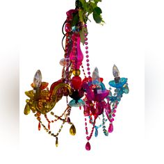 a colorful chandelier hanging from a ceiling in the shape of flowers and butterflies