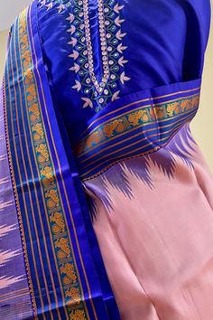 Fabric : Pure Kanjivaram Silk Type : Thread work korvai contrast Body Color : Light lotus pink Border Color : Bluish purple Blouse Color: Bluish purple Pallu Color: Bluish purple Approximate height - 46 - 52" Approximate weight - 1.4 lbs Approximate Length - 6.25 - 6.50 mtrs (inclusive of blouse length) Technique on the blouse : Aari and mirror work Saree comes with fall, picot and tassels done when applicable. Blouse piece is cut. Kindly Note : The colors you see on your device may vary due to Pink Silk Kurta With Cutdana Detail, Pink Silk Kurta With Cutdana, Transitional Season Pink Salwar Kameez With Cutdana, Traditional Pink Cotton Silk Churidar, Pink Cotton Silk Churidar For Diwali, Traditional Pink Anarkali Set In Cotton Silk, Transitional Pink Churidar With Traditional Drape, Pink Traditional Churidar For Transitional Season, Transitional Silk Pink Kurta