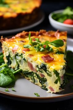 a slice of quiche on a plate with spinach