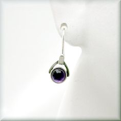 "Gorgeous amethyst cabochon earrings - a rich, deep purple that looks absolutely luscious. The setting is slightly oxidized sterling to make the stone really stand out. Beautiful for anyone who loves purple or as a gift for that person with a February birthday. The earrings are about 7/8\" long (2.2 cm) from top of earwire. Sterling silver. The amethyst cabochons are 5 mm in size. Jewelry is packaged in a cotton lined box for gift-giving. See more Bonny Jewelry at http://bonnyjewelry.etsy.com" Elegant Purple Cabochon Earrings, Modern Purple Gemstone Earrings, Elegant Cabochon Adjustable Earrings, Modern Amethyst Gemstone Earrings, Purple Round Pierced Earrings, Modern Cabochon Earrings For Gifts, Modern Cabochon Earrings Gift, Modern Amethyst Earrings As Gift, Round Amethyst Gemstone Earrings