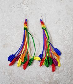 Rainbow Earrings 🌈 Fun and Fabulous! These quirky rainbow coloured earrings are hand knotted on strands of silky soft 1mm rattail cord on stamped 925 sterling silver wires. Light weight and easy to wear, an eye catching and unique design for rainbow lovers and festival goers everywhere. 🌈 Do you see feathers, leaves or ears of wheat?  Approx 12cm total length Quirky and unusual, an affordable  Gift or a treat for yourself. Also available in other exciting colour options!  https://etsy.me/3pUXW Adjustable Rainbow Earrings As Gift, Adjustable Multicolor Fair Trade Earrings, Unique Rainbow Earrings, Rainbow Adjustable Cord Jewelry For Festivals, Rainbow Jewelry With Adjustable Cord For Festivals, Rainbow Festival Jewelry With Adjustable Cord, Rainbow Tassel Earrings For Gifts, Handmade Rainbow Earrings For The Beach, Multicolor Macrame Earrings As Gift