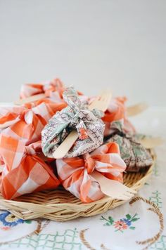 a basket filled with lots of different types of cloths on top of a table