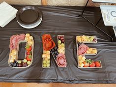 the table is set up with different fruits and vegetables to spell out the word diet