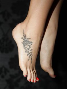 a woman's foot with a tattoo on it