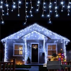 a house is decorated with christmas lights and garlands