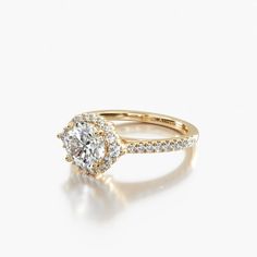 a yellow gold engagement ring with an oval cut diamond and pave set diamonds around the band