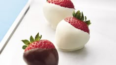 three chocolate covered strawberries sitting on top of a white plate next to each other