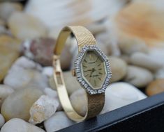 "Geneve sleek 14kt gold wristwatch with a halo of diamonds around the dial. This solid gold ladies watch is custom fit for a 6 3/4\" wrist. Quartz style is convenient never needing to wind. In the watch, you need to replace the battery. New battery installed should last 1-2 years. Watch Weight: 22 g. This item is pre-owned vintage and may show some wear commensurate with its age. We will point out any flaws, post pictures, and describe to the best of our ability so that you can examine the piece Gold Watches With Diamond Accents For Wedding, Gold Wedding Watches With Diamond Accents, Wedding Yellow Gold Diamond Watch, Art Deco Jewelry Vintage, Ladies Bracelet, Bracelet Diamond, Vintage Jewelry Art, Vintage Jewelry Necklace, Art Deco Necklace