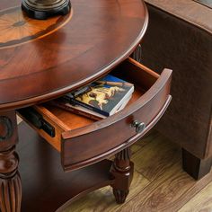 a wooden table with an open drawer on it's side and a clock on top