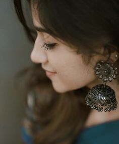 a close up of a person wearing earrings