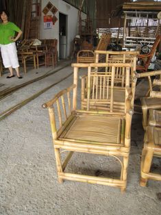 a woman standing next to bamboo chairs and tables