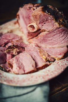 sliced meat sitting on top of a pink plate