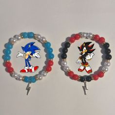 two bracelets with sonic and tails on them, one beaded in red, the other made out of glass beads