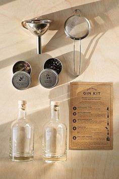 an assortment of bottles and spoons sitting on a table