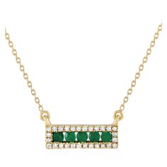 Add a touch of luxury to any ensemble with this impeccably crafted necklace. Suspended at the center of an 18 chain, youll find a 14K Yellow Gold pendant measuring 0.15 long by 0.65 wide. A series of Emeralds elevate the center, while sparkling Diamond accents totaling 0.15 carats provide the perfect finishing touch.This jewelry piece is offered in brand new condition and includes a gift box. Elegant Green Necklace With Pave Setting, Formal Gold Emerald Necklace With Single Cut Diamonds, Yellow Gold Necklace With Diamond Accents For May Birthstone, Yellow Gold Emerald Necklace With Diamond Accents As Gift, Green Necklace With Pave Setting As Gift, Yellow Gold Pendants, Diamond Pendant Necklace, Sparkle Diamonds, Diamond Pendant