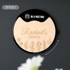 a wooden sign that says rachael's office with flowers in the background