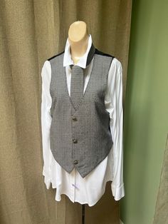 Woman's vest in a size S for the lady who loves the look of a fitted vest worn with a white shirt and a matching necktie.  Vest is Size S. 34" around chest 19" length in back 21" length in front At back there is a 'belt' to adjust the fit on your body.   You see the vest on my size S dress form, about a size 6.  Not a tight fit on the form so vest is probably best for a size 8 lady.  In the second last picture you can see that the small belt in back is tied but can be tighter.   I personally think that the vest would look cool unbuttoned so the neck tie shows. Rayon fabric but looks woven on the tiny checked front of vest and neck tie. Check Vest, Vest And Tie, Dress Form, Vest Outfits, Womens Vest, Men Looks, White Shirt, Look Cool, Vintage Black