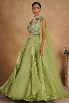 Description:- Featuring a green lehenga in organza base. It is paired with an ornate blouse having sequins, cutdana and stone embellishments, including a sequins embellished dupatta. Accentuate it with statement earrings and heels for a festive occasion or wedding ceremony. About: Color Pista Green Fabric Organza & Net Occasion Party Wear Style Evening dress Work Pearl, Sequins, Cut Dana, zarkan Chest 36 Length 45 Please note: Originally stitched in size 36 but can be altered for size 34 without