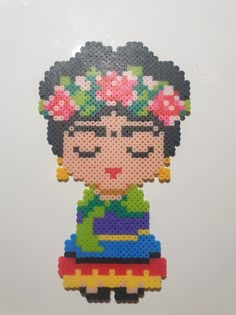 an image of a woman with flowers on her head made out of perler beads