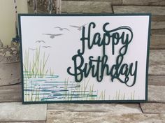 a birthday card with the words happy birthday written in green ink on white paper next to some steps