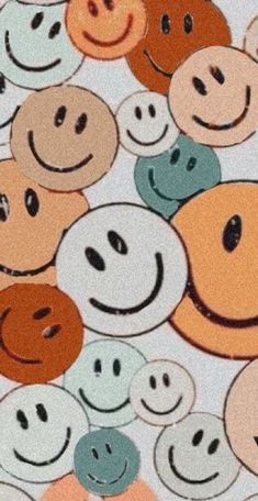 many different colored smiley faces on a white surface