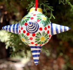 a colorful ornament hanging from a tree